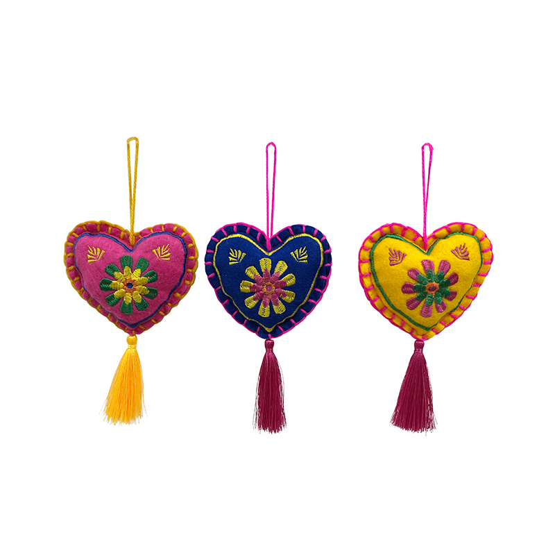 How does the electric embroidered heart-shaped tassel pendant enhance the artistic ambiance of a home through exquisite craftsmanship?